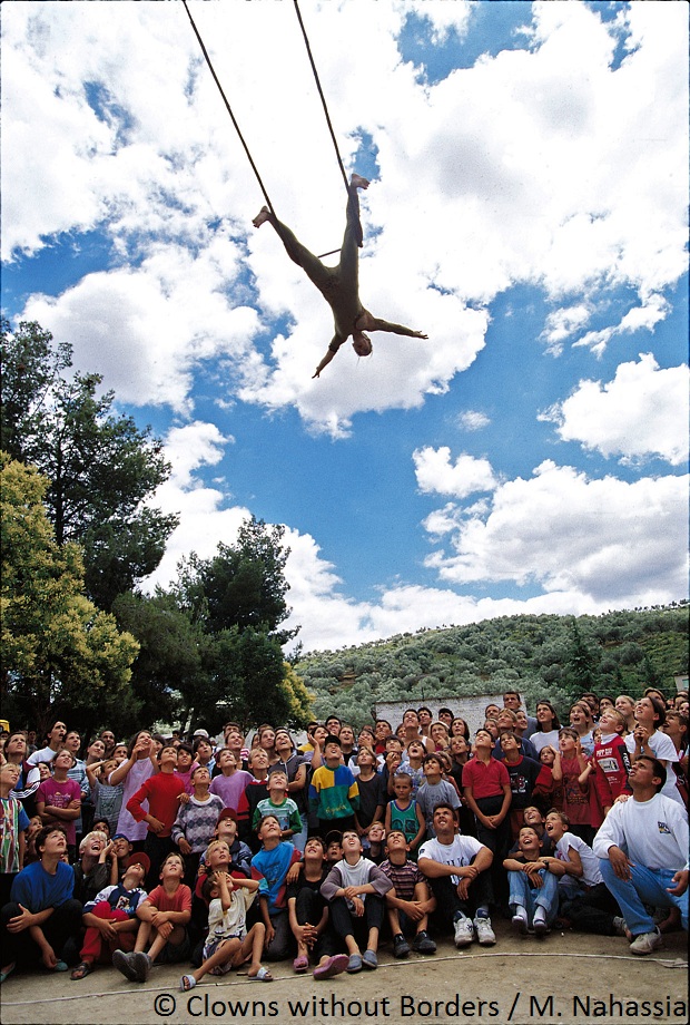 Acrobat swinging above an audience