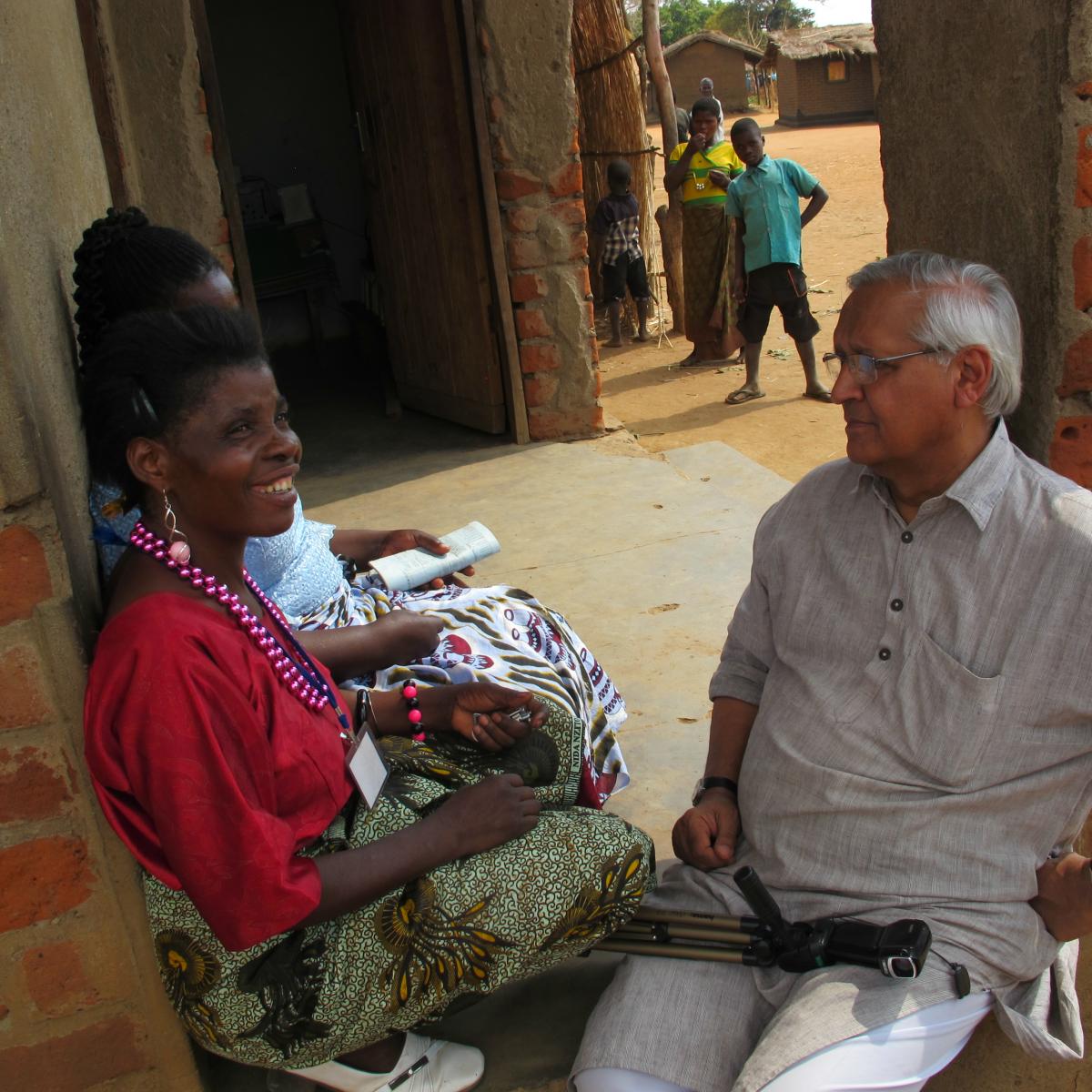 Two African women meet with Bunker Roy of Barefoot College