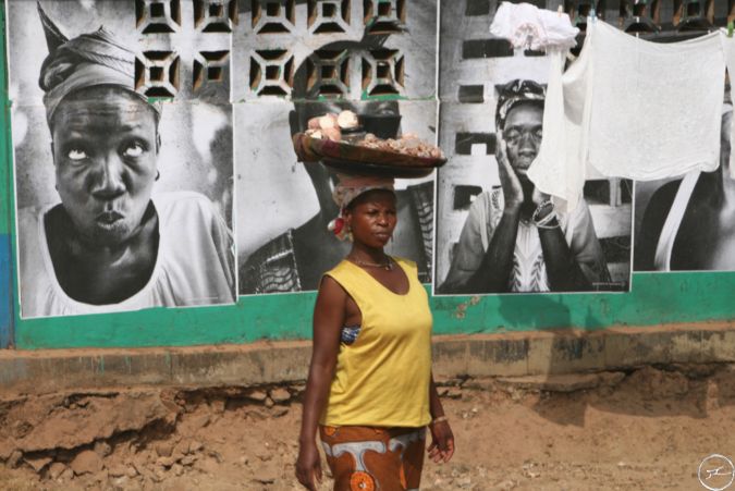 Woman carries belongings on her head in Sierra Leone