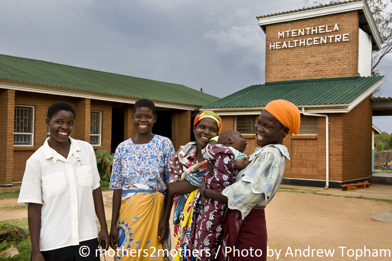 mothers stand outside a mothers2mothers clinic