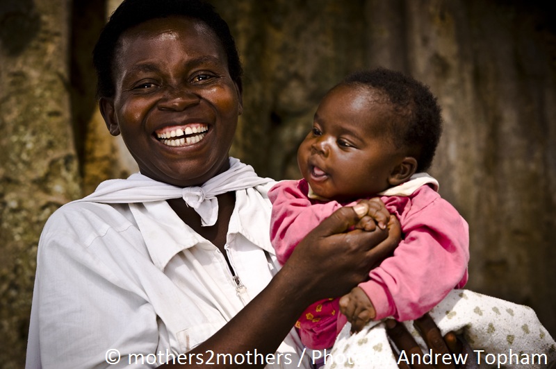 A happy mother holds her healthy baby