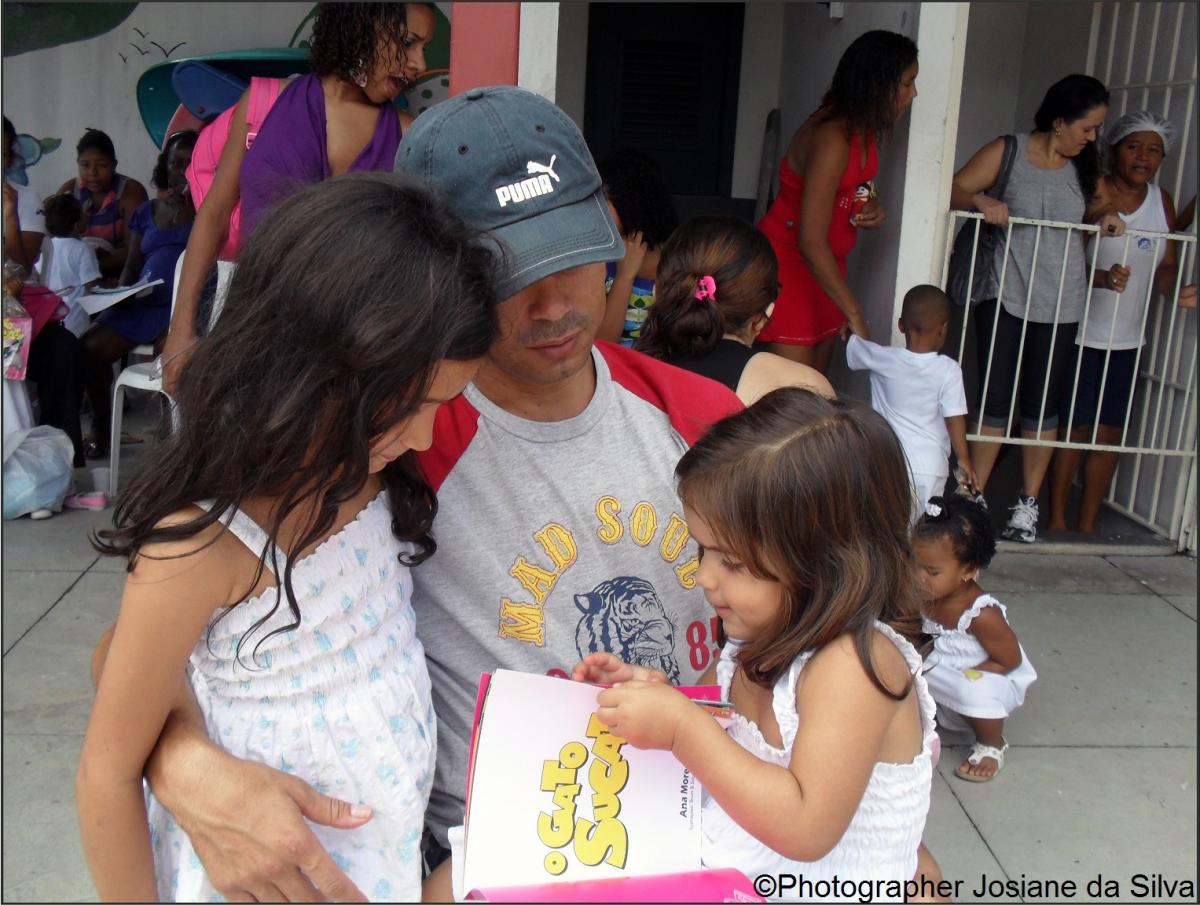 Father holds two daughters in his arms