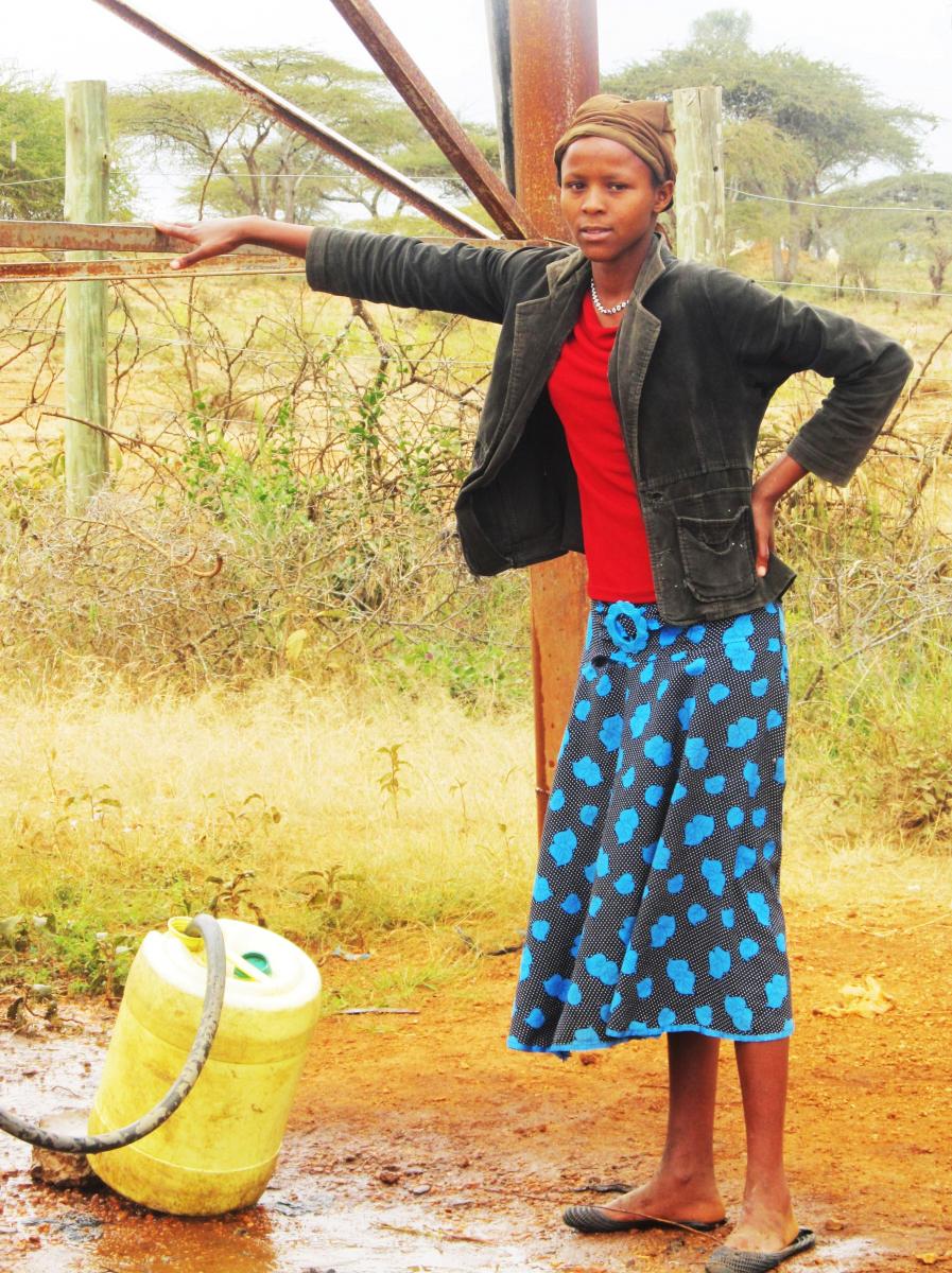 Young Maasai woman fetches water