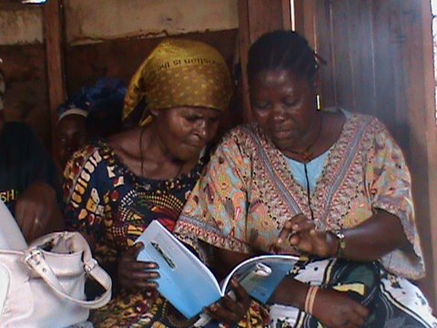 Two Congolese women learning to read together