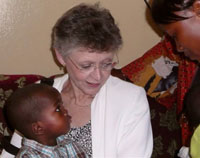 Francoise Barre-Sinoussi with an African boy and his mother