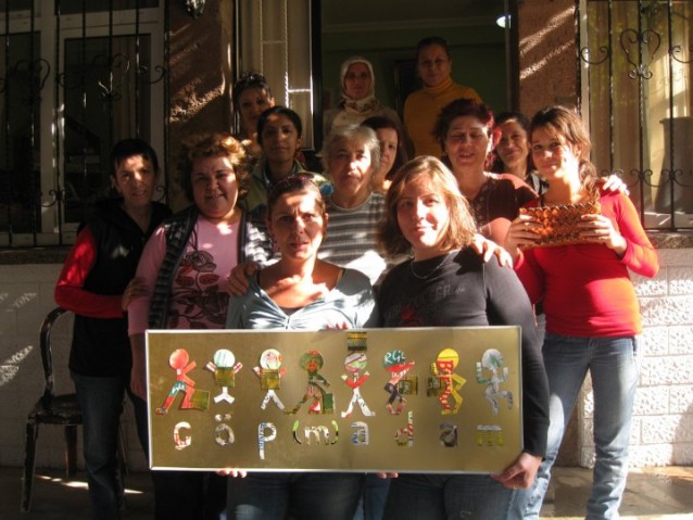 çöp(m)adam's garbage ladies pose together in front of their workshop