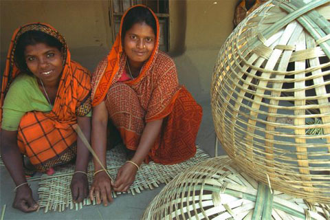 Women weave baskets in Bangladesh