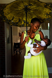 Mother holding her child under an umbrella
