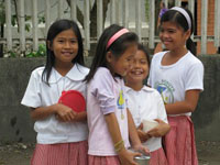 Four young girls laugh and play