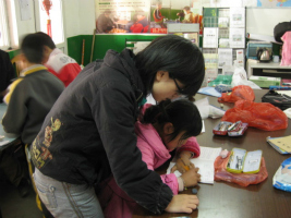 A tutor helps a young migrant child in China